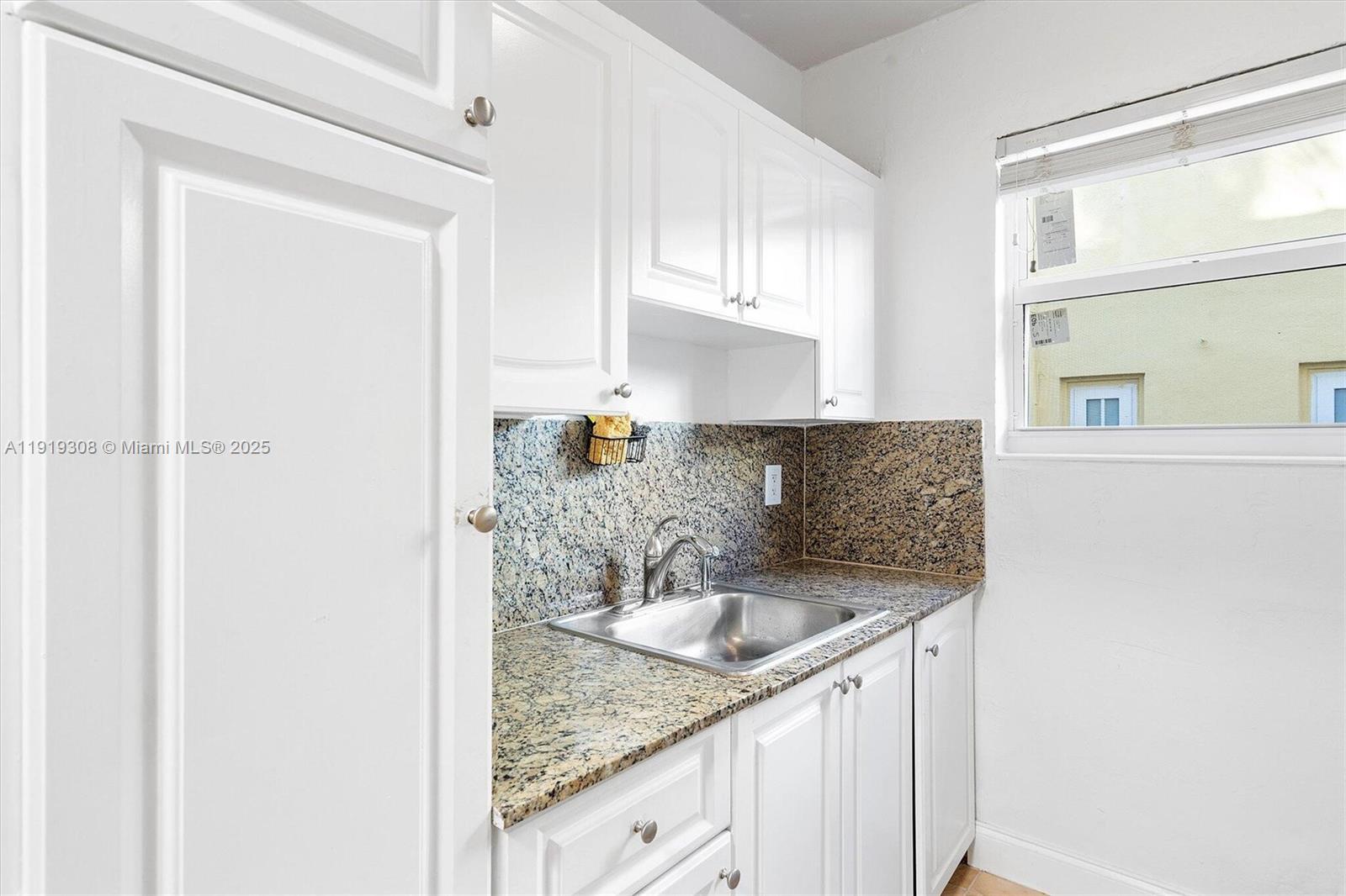 7510 Byron Avenue, Unit 8 Miami Beach, FL 33141 - Photo 6 of 15 a kitchen with granite countertop a sink and a granite counter tops
