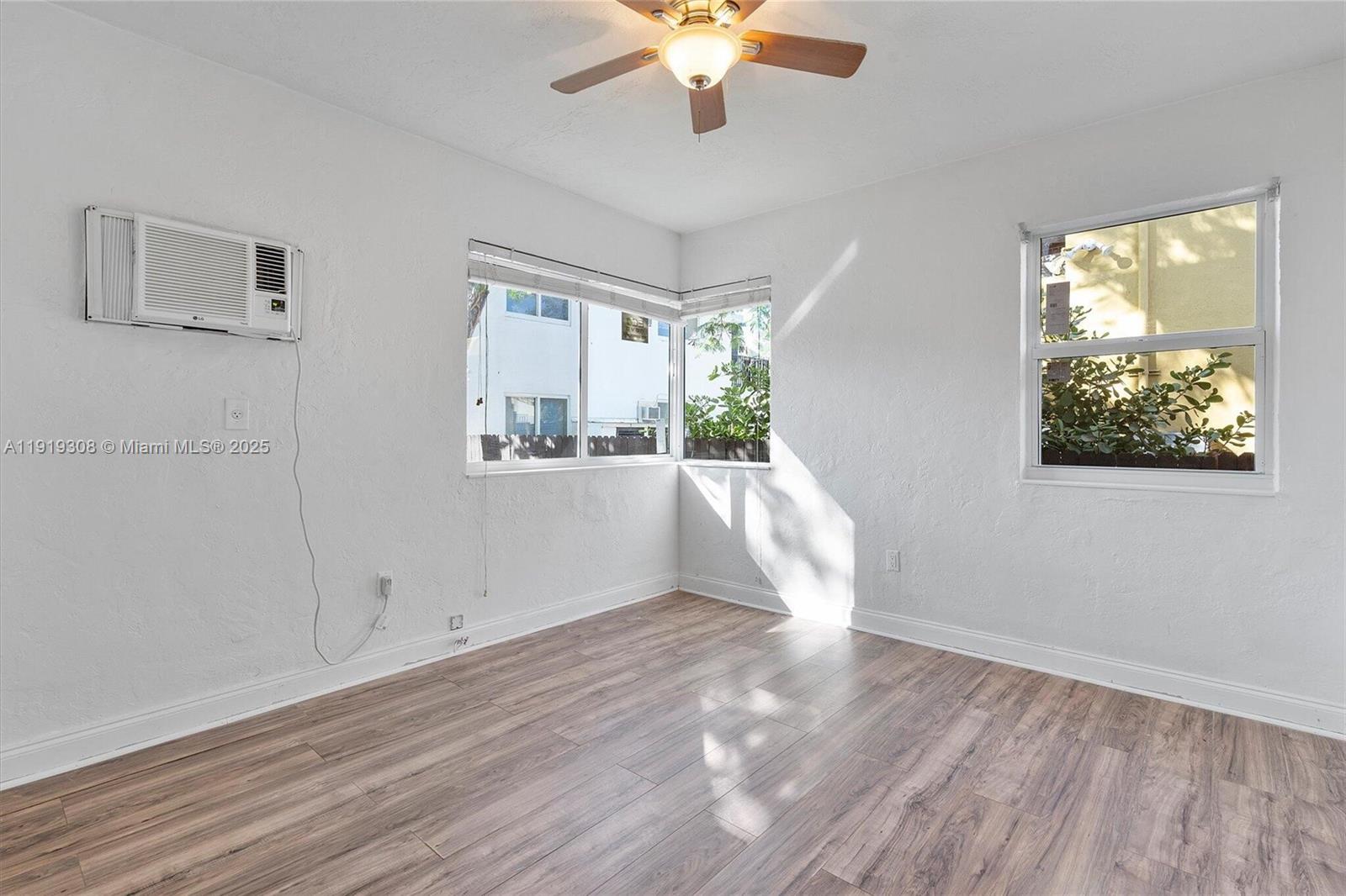 7510 Byron Avenue, Unit 8 Miami Beach, FL 33141 - Photo 7 of 15 a view of empty room with wooden floor and fan