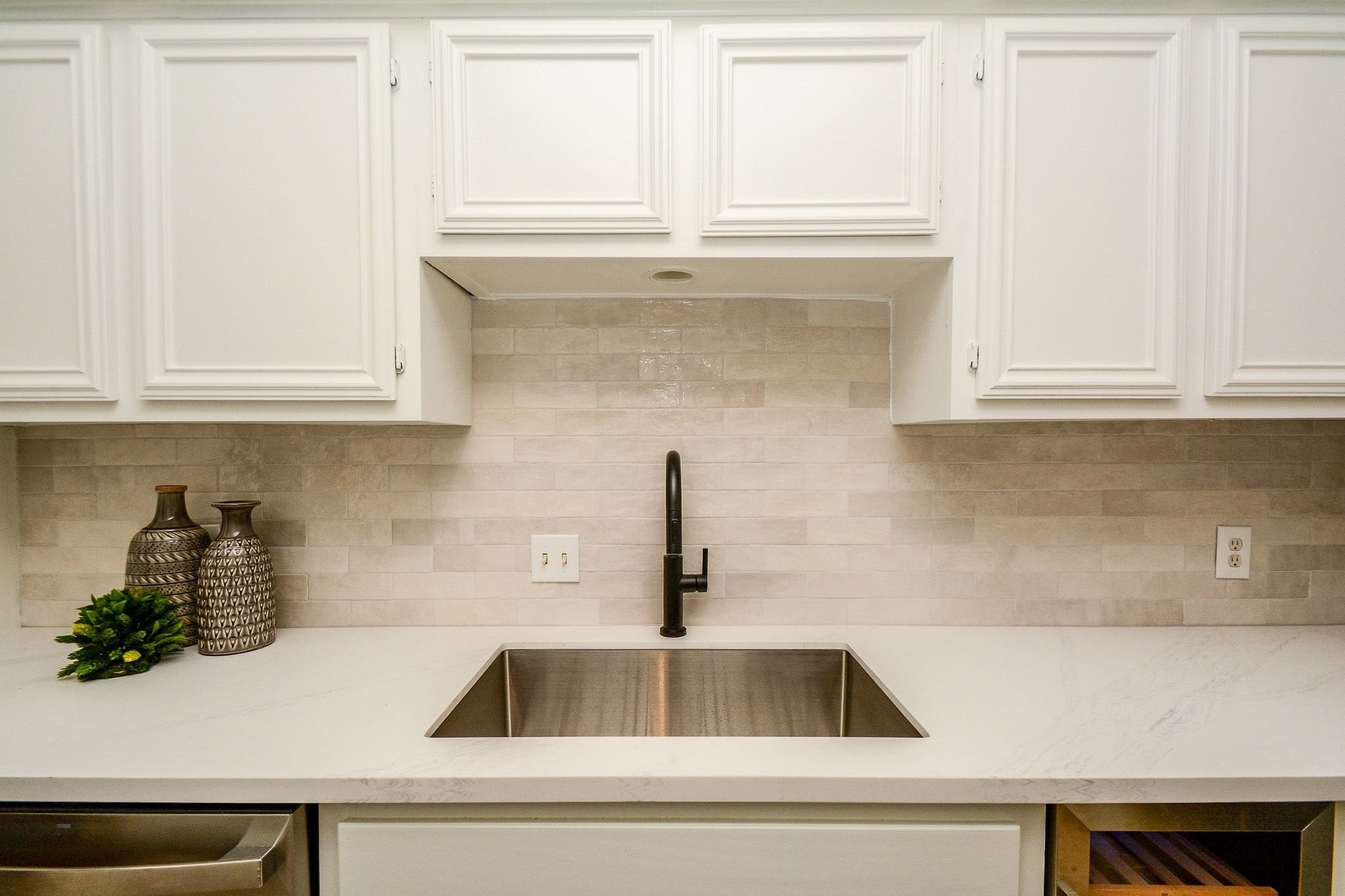820 Harold Street Houston, TX 77006 - Photo 8 of 33 An undermount sink with a matte black pull-down faucet pairs with an integrated wine fridge, a nice bonus for entertaining.