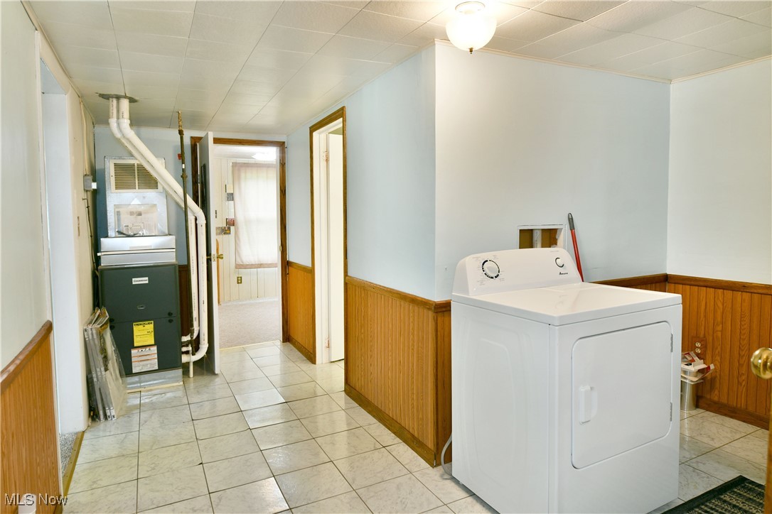 5578 Shaffer Road Northwest Warren, OH 44481 - Photo 44 of 48 Laundry area with washer / clothes dryer, a wainscoted wall, wood walls, and heating unit