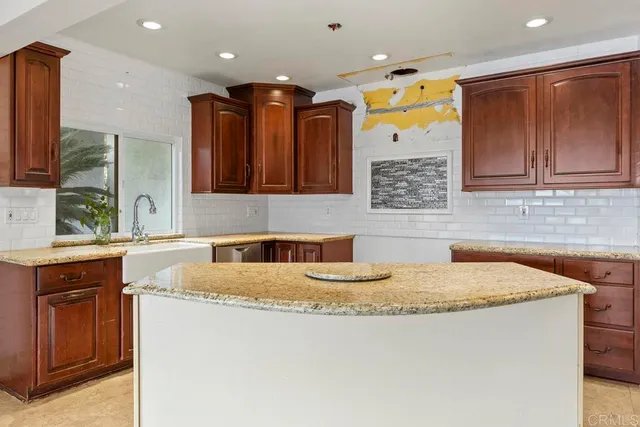 a kitchen with a sink and a refrigerator