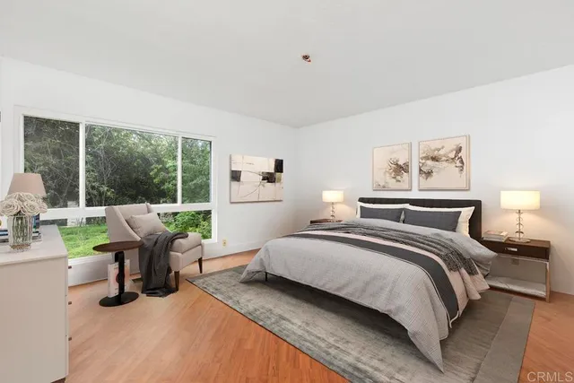 a bedroom with a bed and a large window