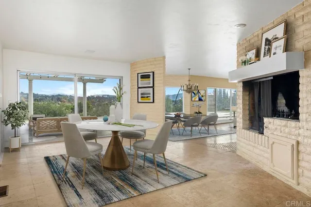 a living room with furniture large window and a table