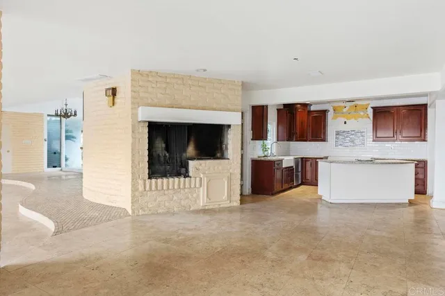 a view of a kitchen with furniture and an empty room