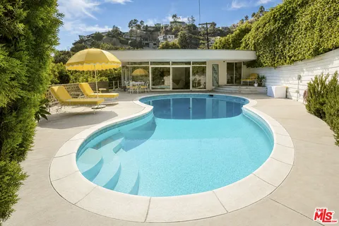 a view of a swimming pool with a patio