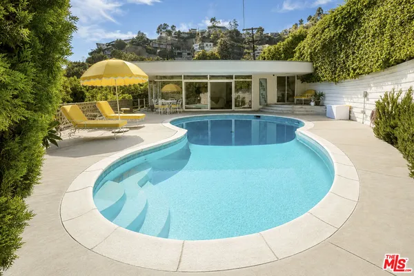 a view of a swimming pool with a patio