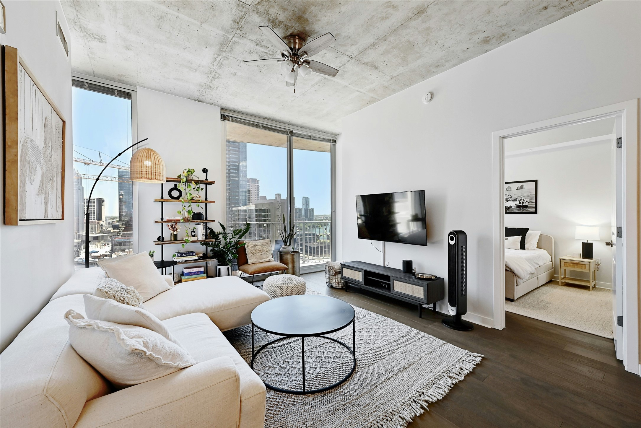 360 Nueces Street, Unit 1809 Austin, TX 78701 - Photo 1 of 25 Open-concept living area featuring dark wood-finish flooring and a concrete ceiling