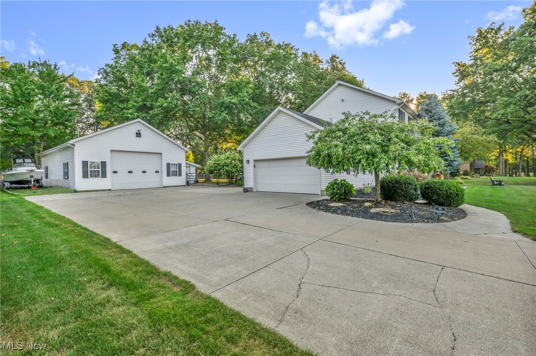 14902 Kneisel Road Vermilion, OH 44089 - Photo 42 of 49 View of side of property featuring a yard and an outdoor structure