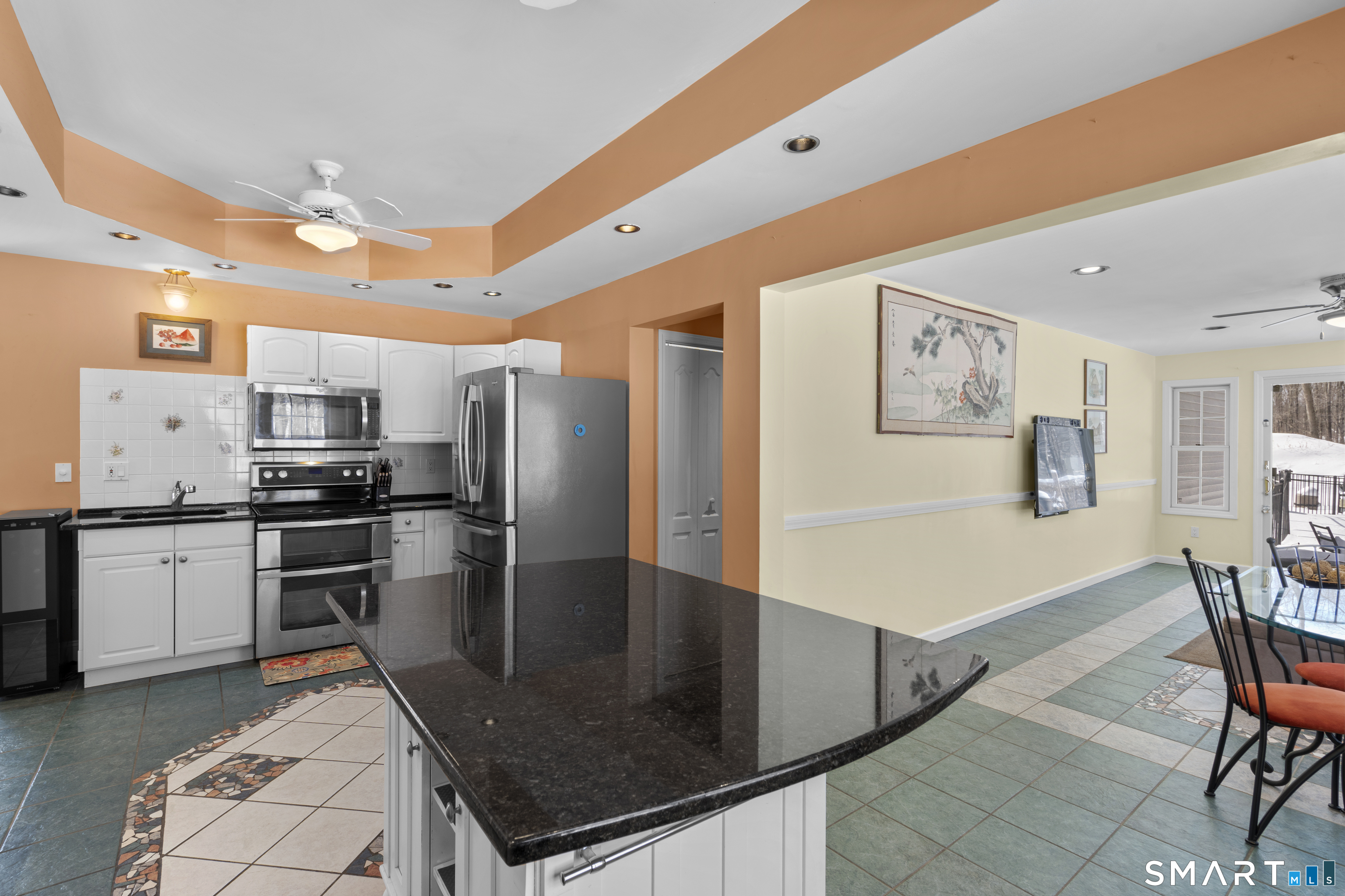 1729 Litchfield Road Watertown, CT 06795 - Photo 12 of 39 a kitchen with stainless steel appliances granite countertop a refrigerator a stove a sink a dining table and chairs with wooden floor