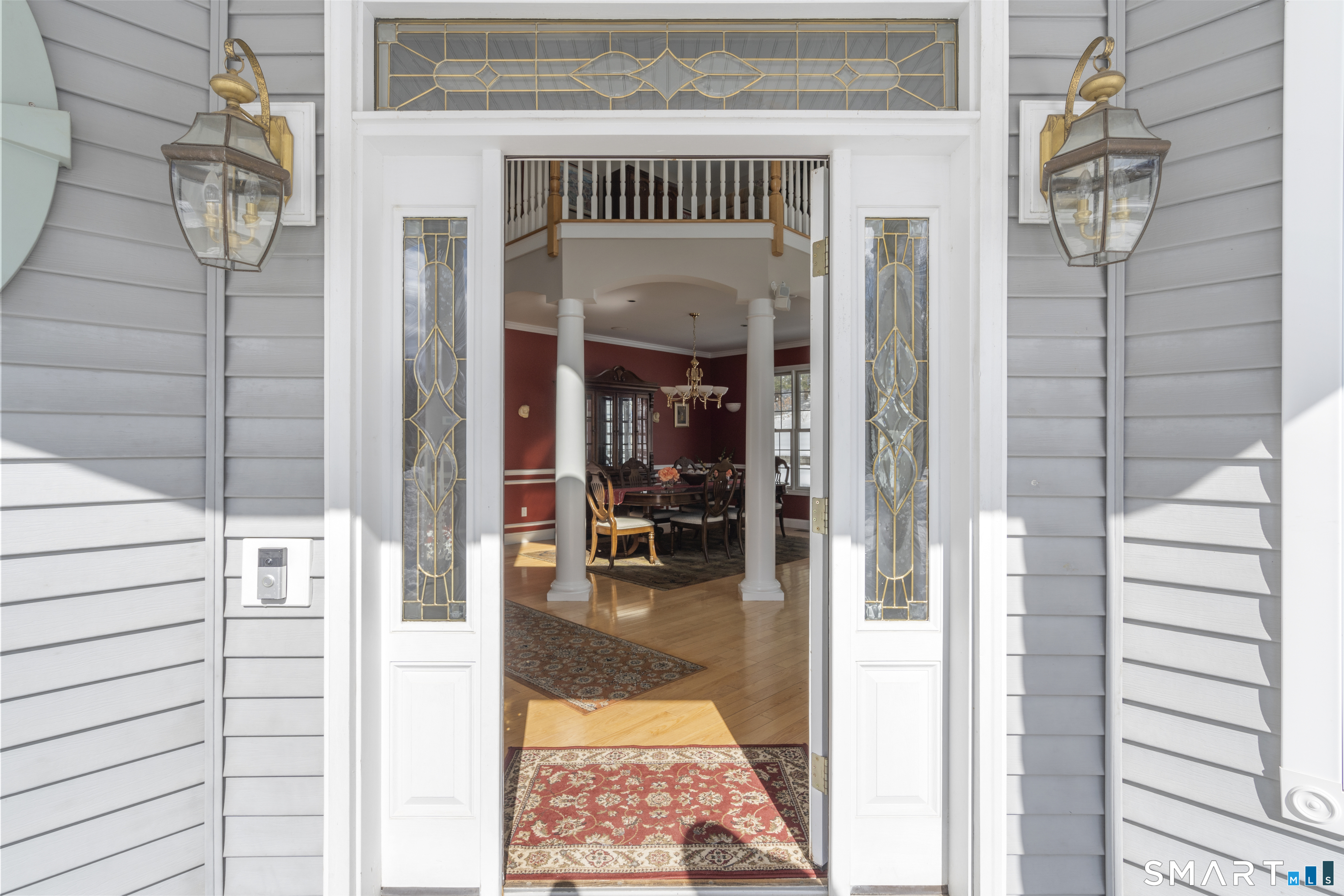 1729 Litchfield Road Watertown, CT 06795 - Photo 5 of 39 a view of a hallway with a dining table and chandelier