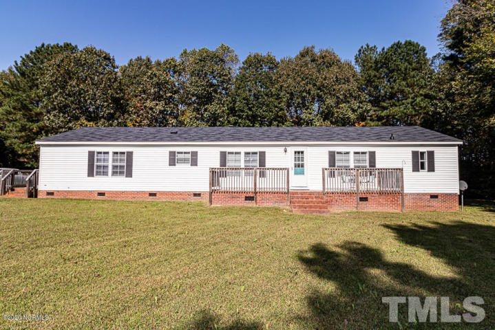 501 Williams Road Spring Hope, NC 27882 - Photo 22 of 22 a front view of house with yard and trees in the background