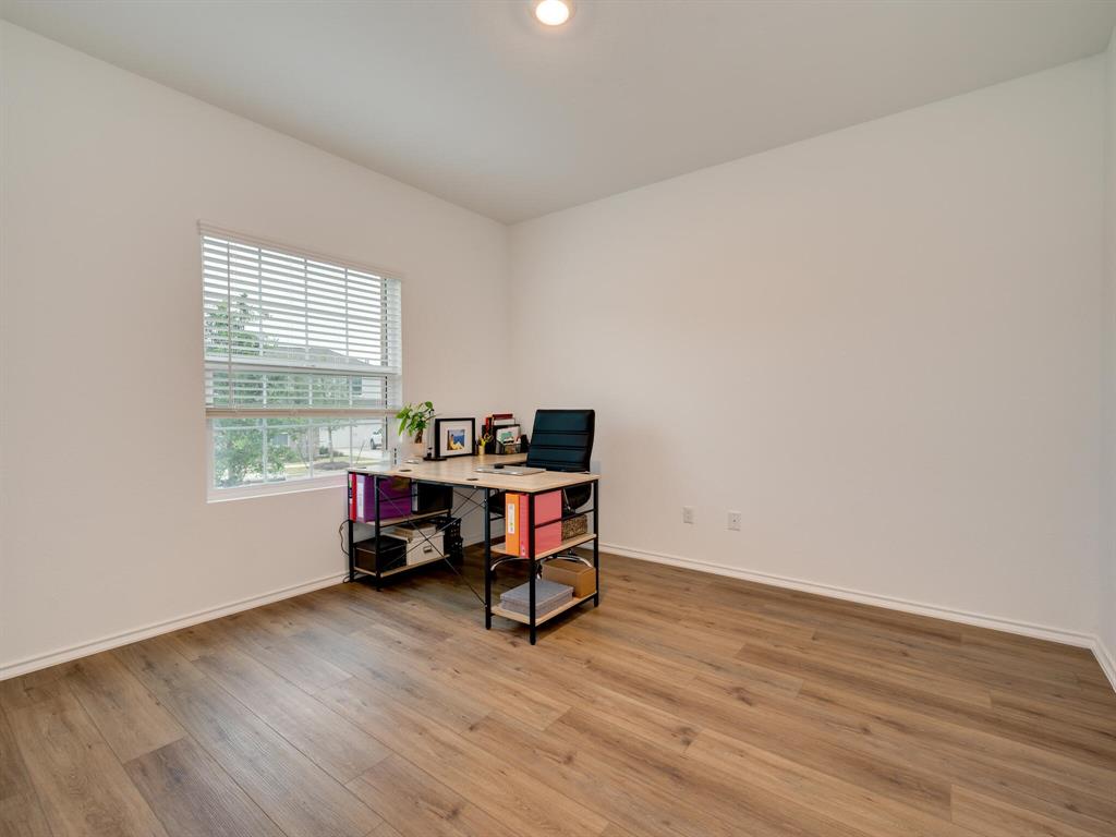1208 Sweetspire Street Leander, TX 78641 - Photo 4 of 36 Room featuring wood-finish flooring, white walls, and a single window with blinds