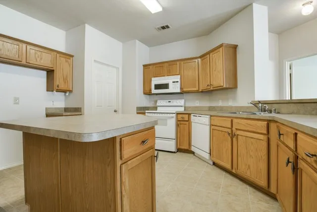 a kitchen with a sink stove and cabinets