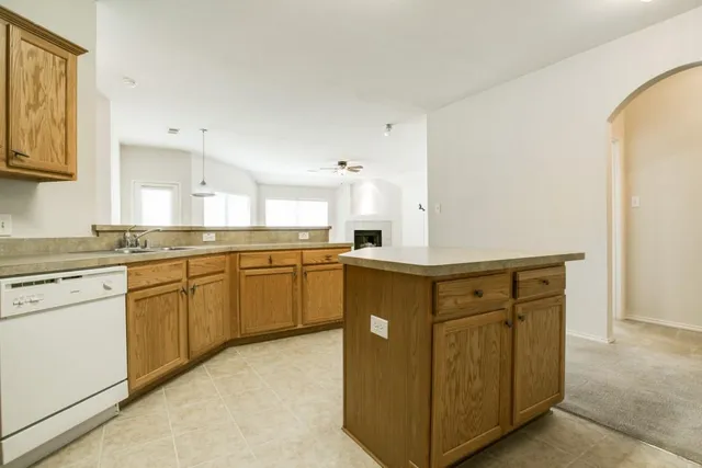 a kitchen with stainless steel appliances granite countertop a stove and a sink