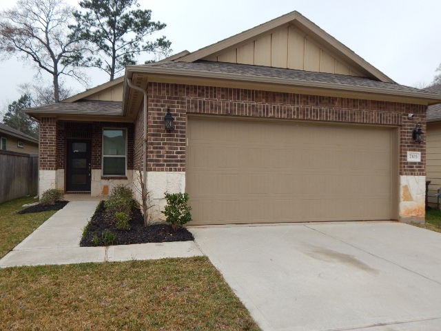 7103 Silverleaf Oak Street Conroe, TX 77304 - Photo 1 of 20 a front view of a house with garden