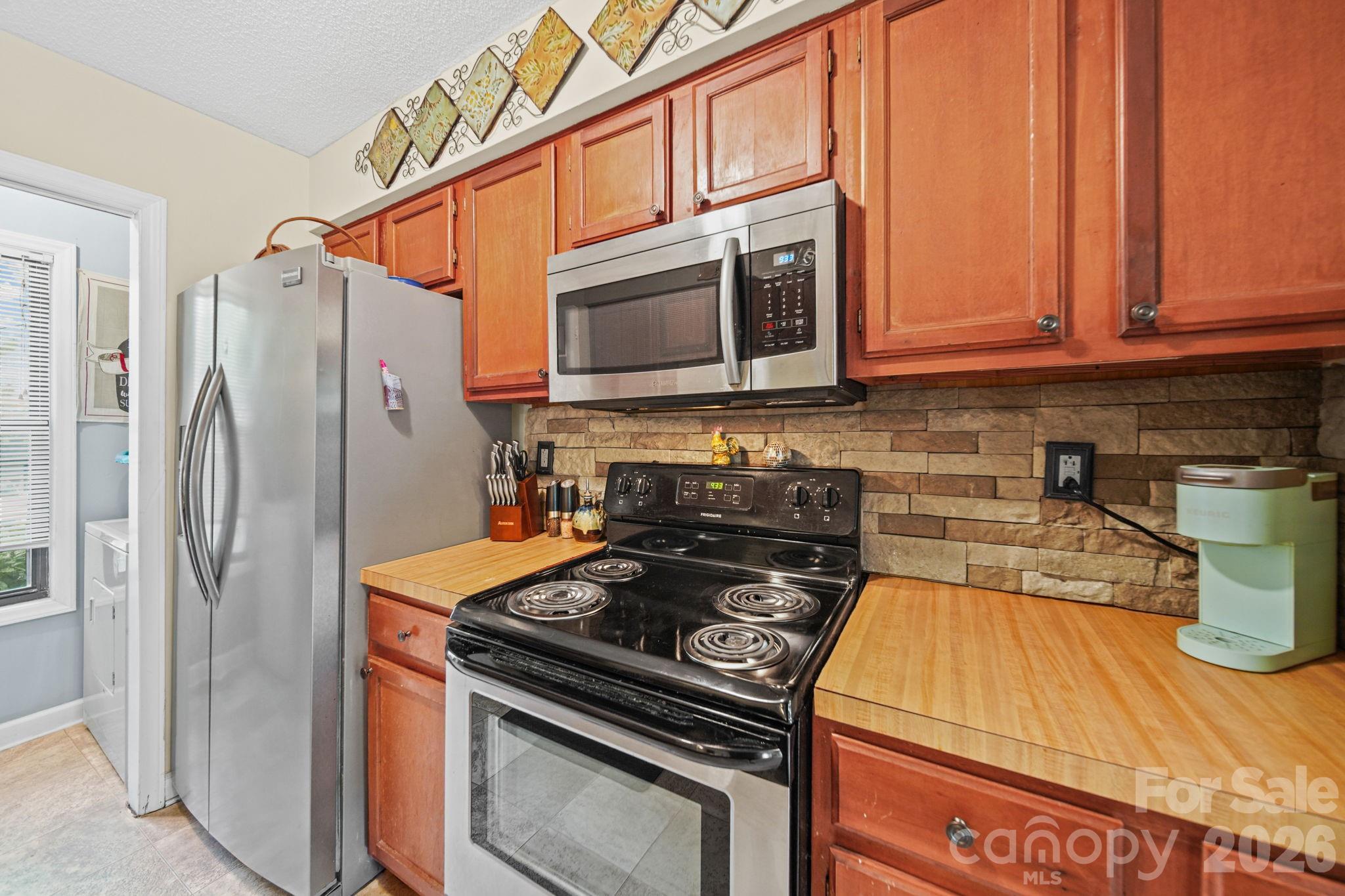 2788 Red Bud Lane Fort Mill, SC 29715 - Photo 11 of 35 a kitchen with a stove and a refrigerator