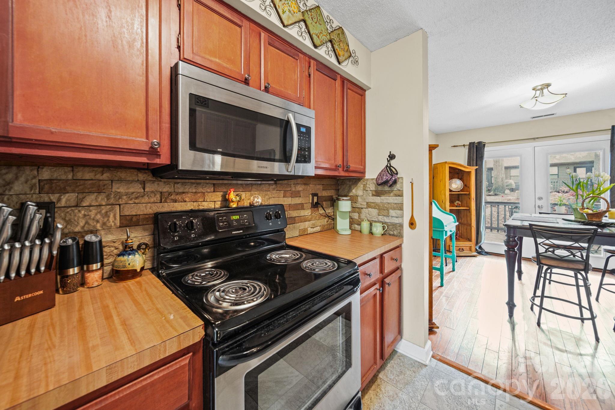 2788 Red Bud Lane Fort Mill, SC 29715 - Photo 13 of 35 a kitchen with stainless steel appliances granite countertop a stove a sink and a microwave