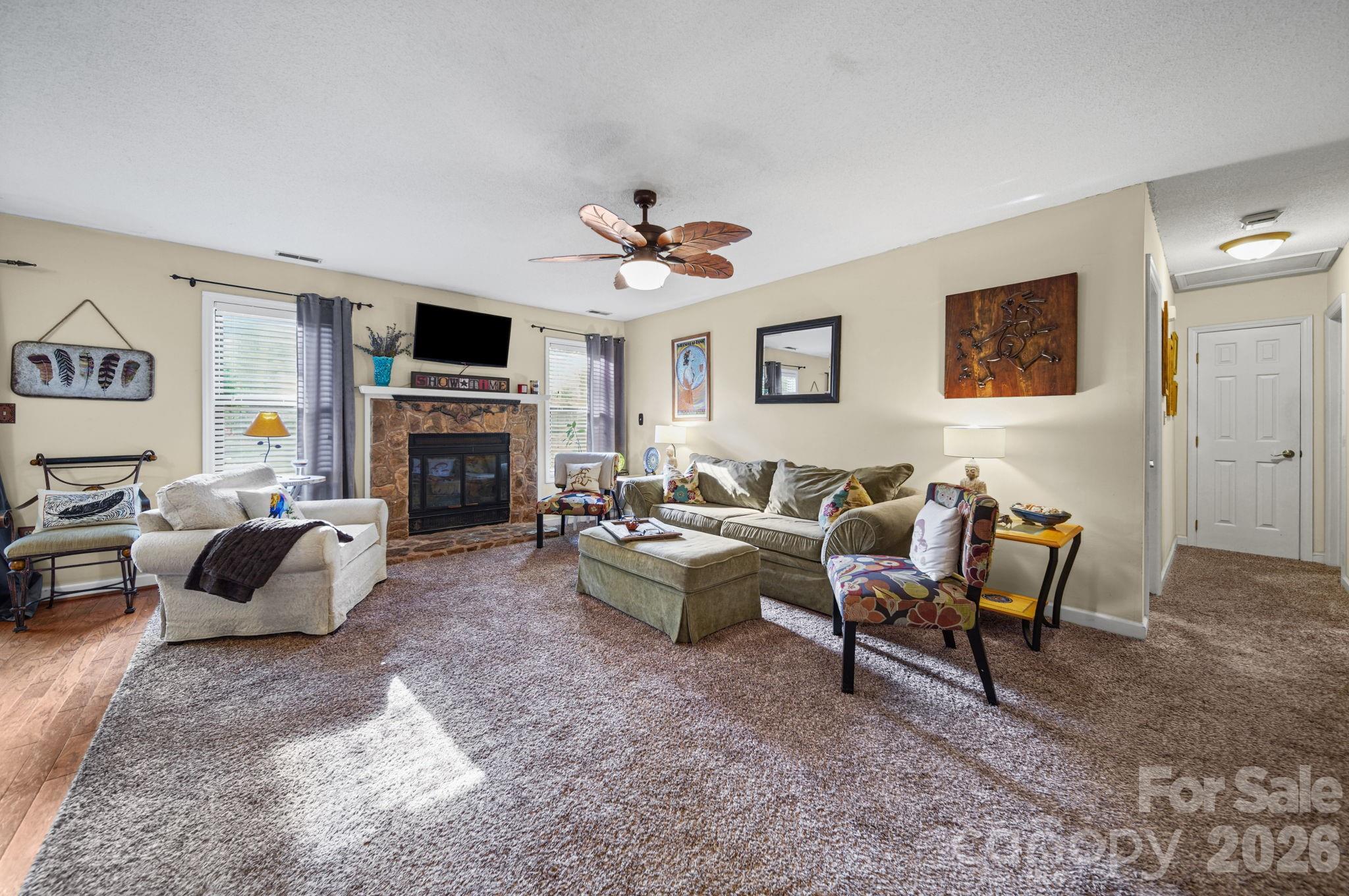 2788 Red Bud Lane Fort Mill, SC 29715 - Photo 2 of 35 a living room with furniture a fireplace and a flat screen tv