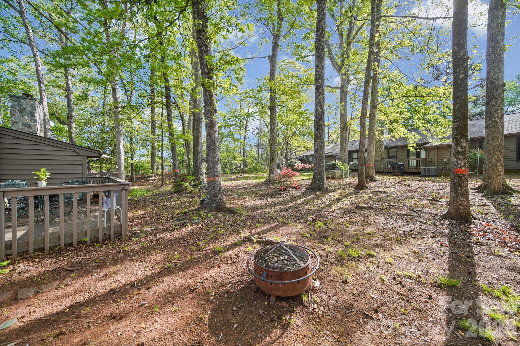 2788 Red Bud Lane Fort Mill, SC 29715 - Photo 28 of 35 a view of a backyard with table and chairs and wooden fence
