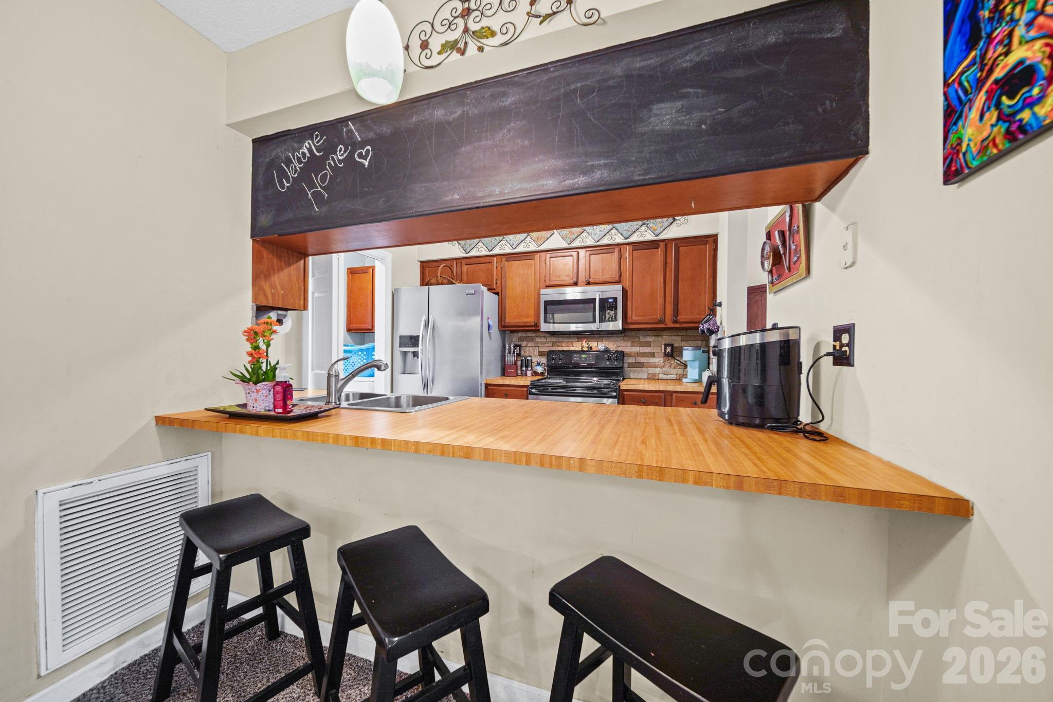2788 Red Bud Lane Fort Mill, SC 29715 - Photo 3 of 35 a dining room with furniture and a kitchen view