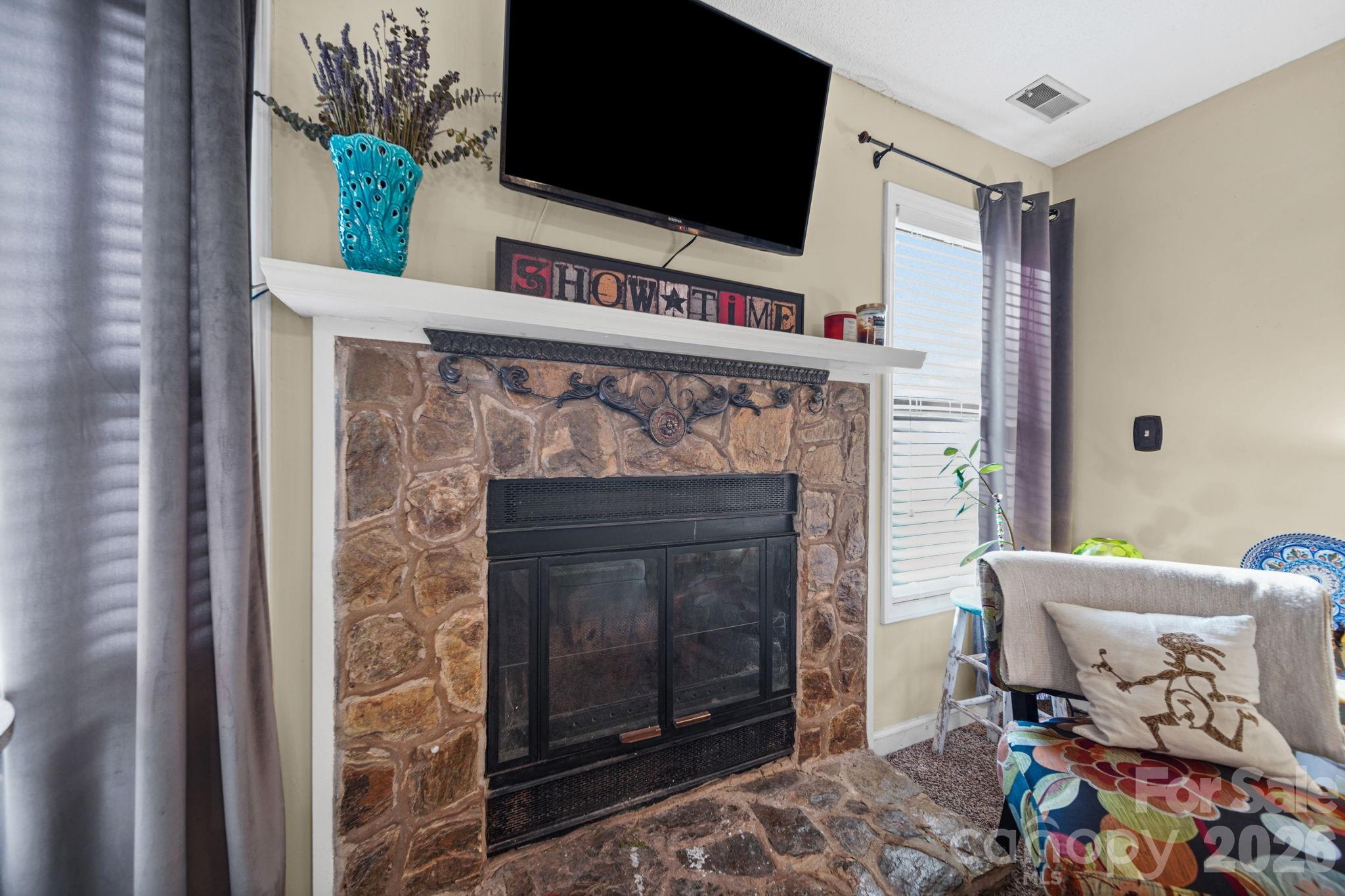 2788 Red Bud Lane Fort Mill, SC 29715 - Photo 7 of 35 a living room with a fireplace and a flat screen tv