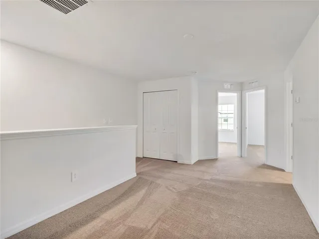 a view of an empty room and closet area
