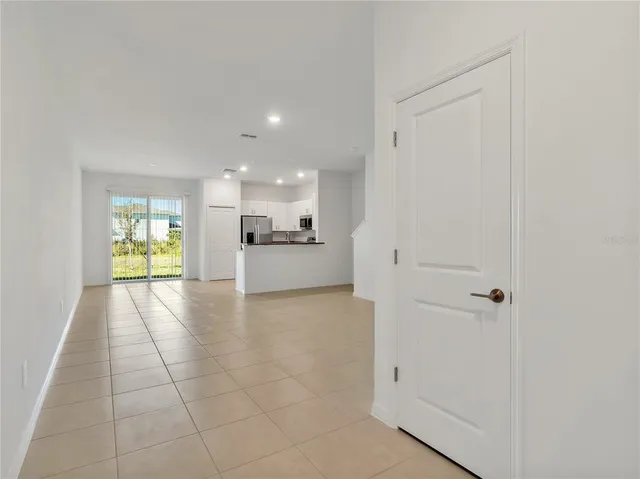 a view of a kitchen with a sink and a refrigerator