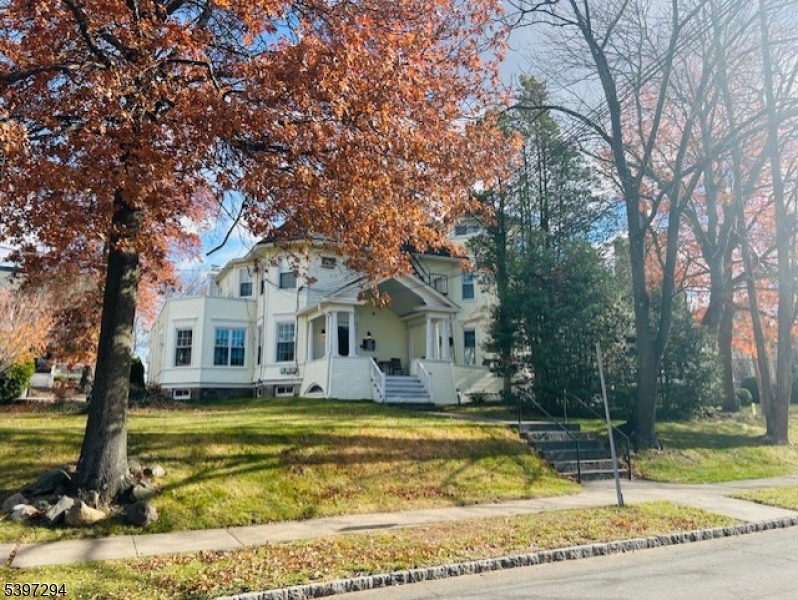 7 Norwood Avenue, Unit 4 Summit, NJ 07901 - Photo 4 of 4 a front view of a house with a yard table and chairs
