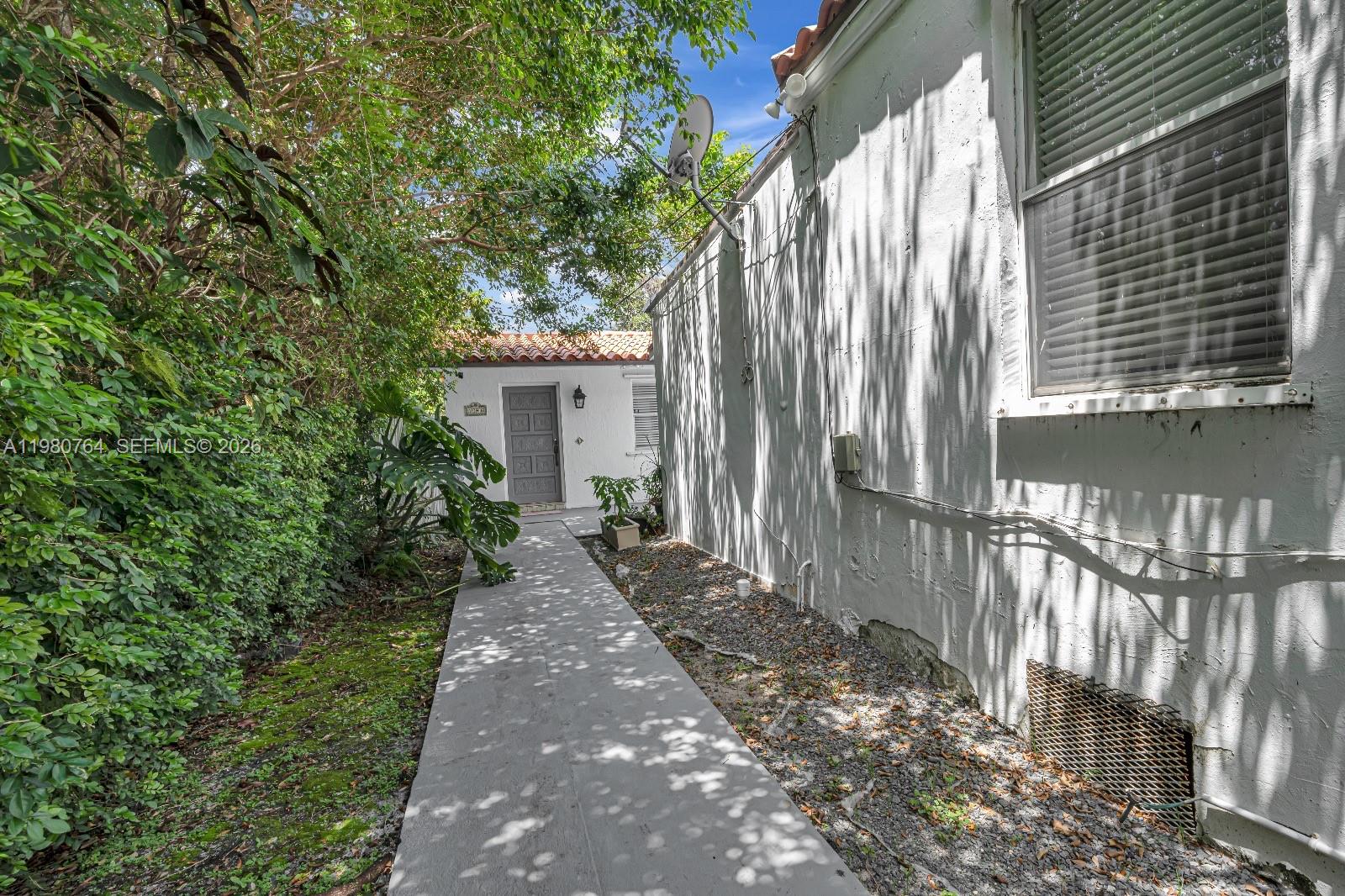 1044 Southwest 13th Court, Unit 2 Miami, FL 33135 - Photo 3 of 17 a view of a pathway of a house with a yard