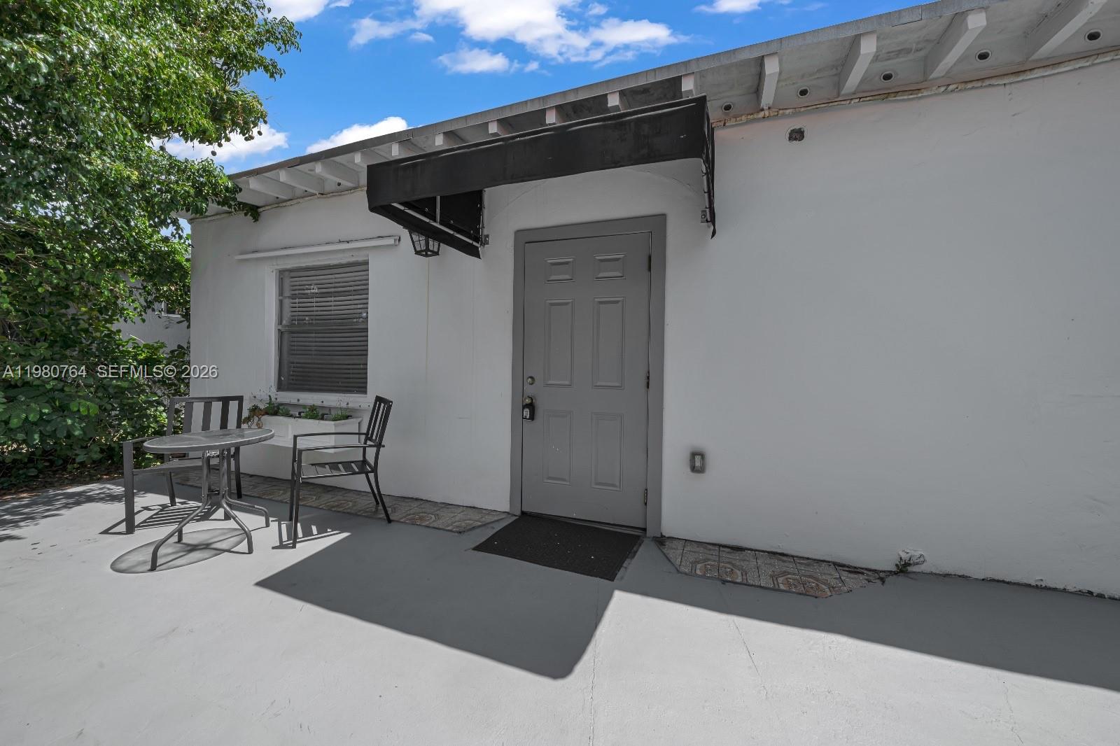 1044 Southwest 13th Court, Unit 2 Miami, FL 33135 - Photo 4 of 17 a view of backyard with a chair and table