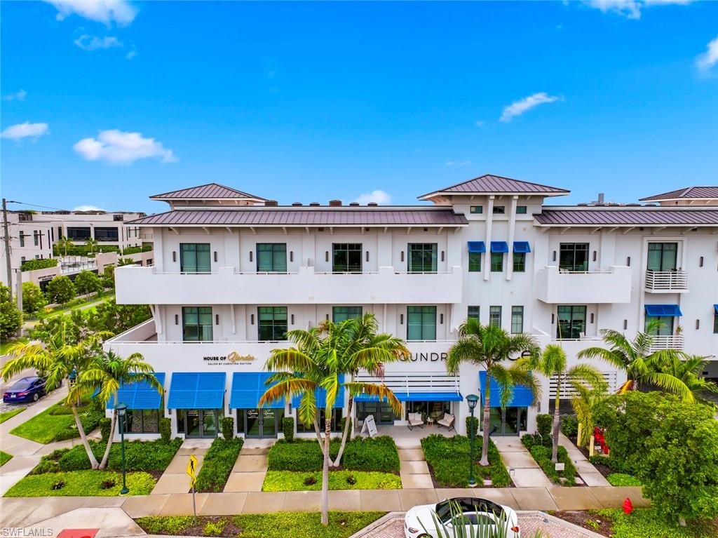 a front view of multiple houses with yard