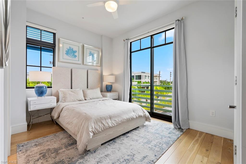 101 8th Street South, Unit 201 Naples, FL 34102 - Photo 13 of 21 a bedroom with a bed and a window