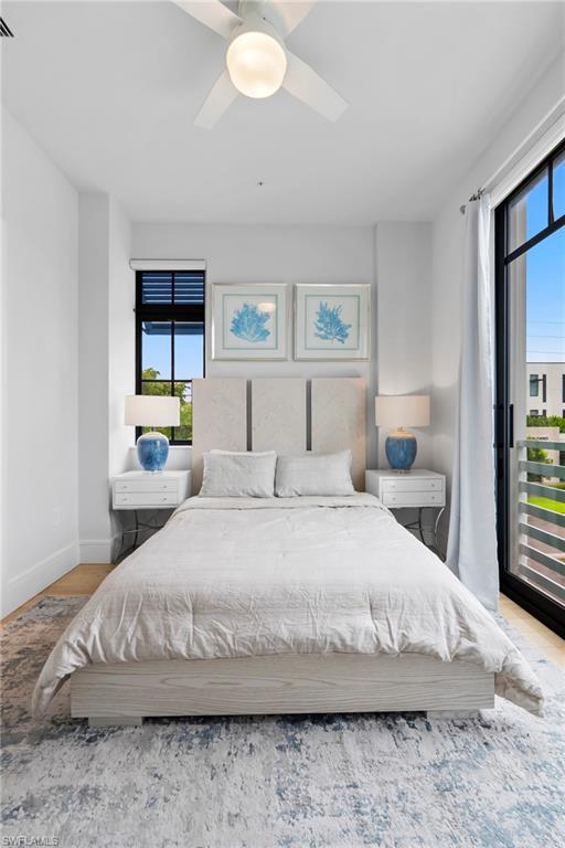 101 8th Street South, Unit 201 Naples, FL 34102 - Photo 14 of 21 a bedroom with a bed window and wall painting