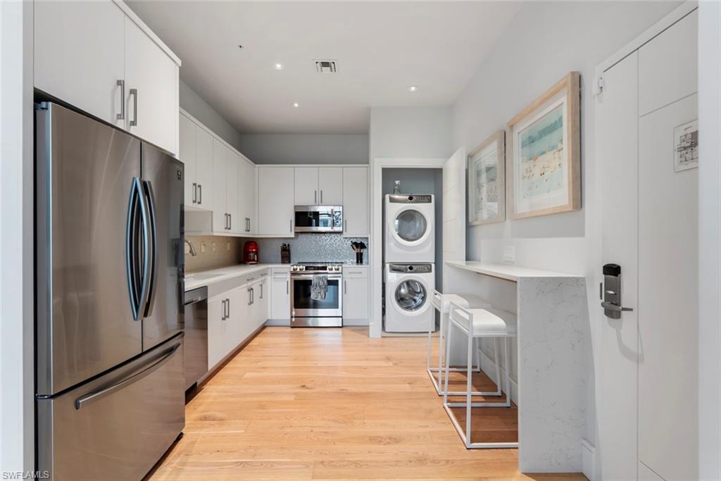 101 8th Street South, Unit 201 Naples, FL 34102 - Photo 6 of 21 a kitchen with stainless steel appliances a refrigerator sink and microwave