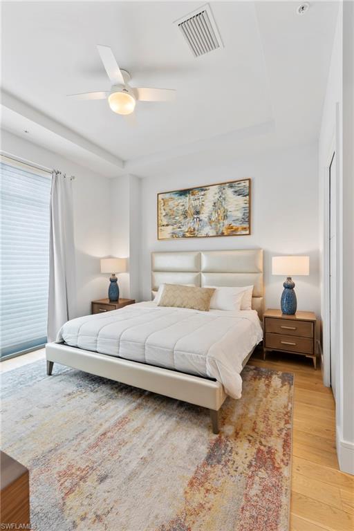 101 8th Street South, Unit 201 Naples, FL 34102 - Photo 9 of 21 a bedroom with a bed and a couch