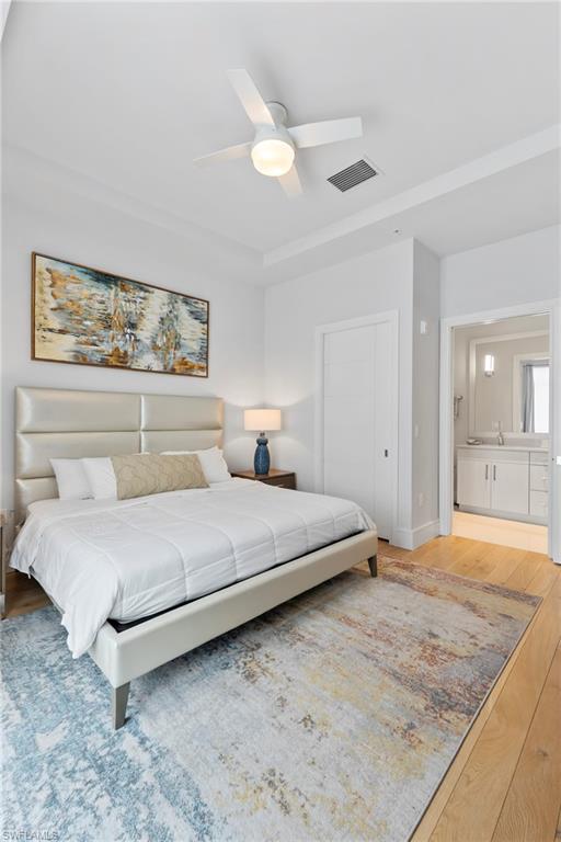 101 8th Street South, Unit 201 Naples, FL 34102 - Photo 10 of 21 a bedroom with a bed and a painting on the wall