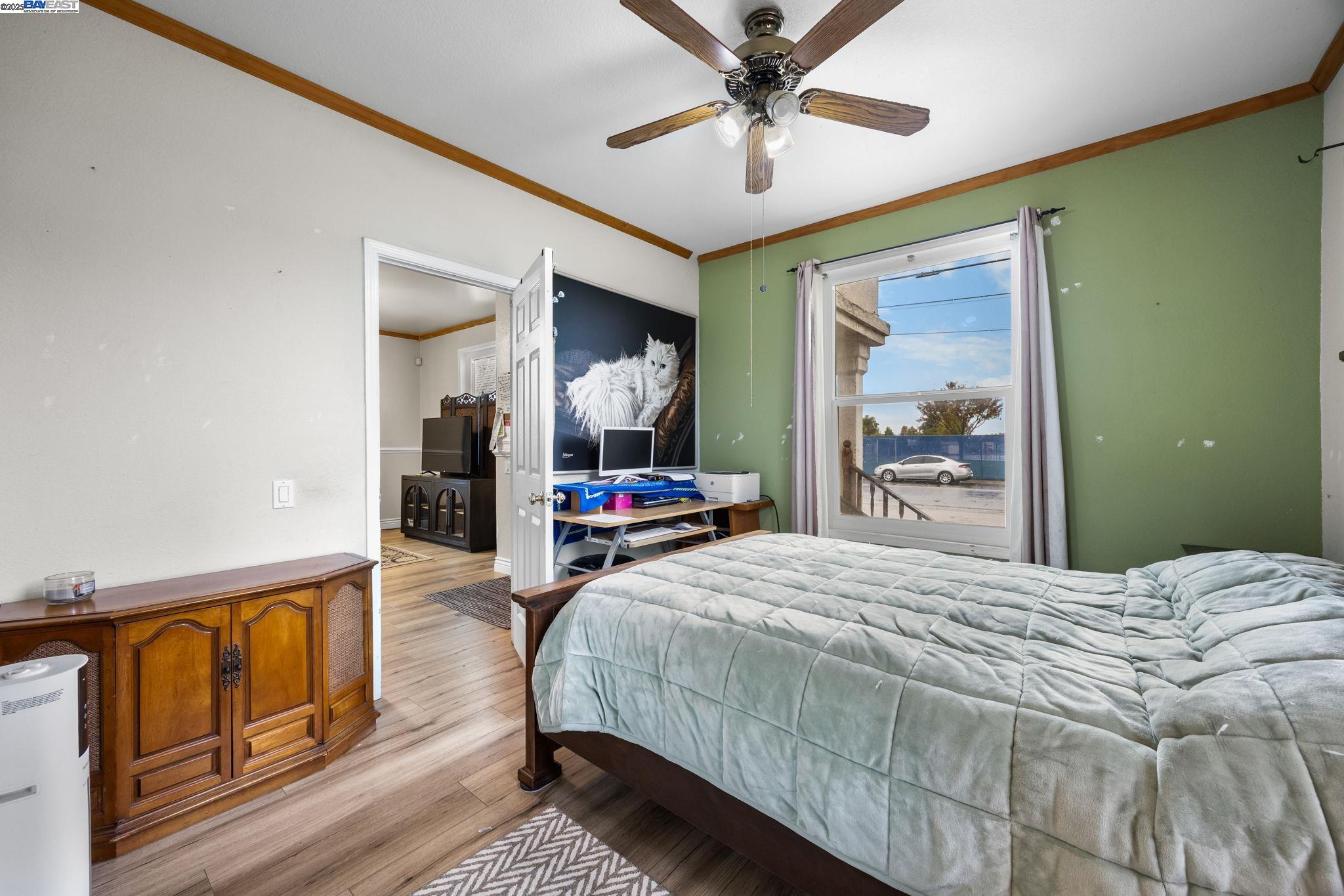 2421 West Rumble Road Modesto, CA 95350 - Photo 13 of 25 a bedroom with a bed and wooden floor