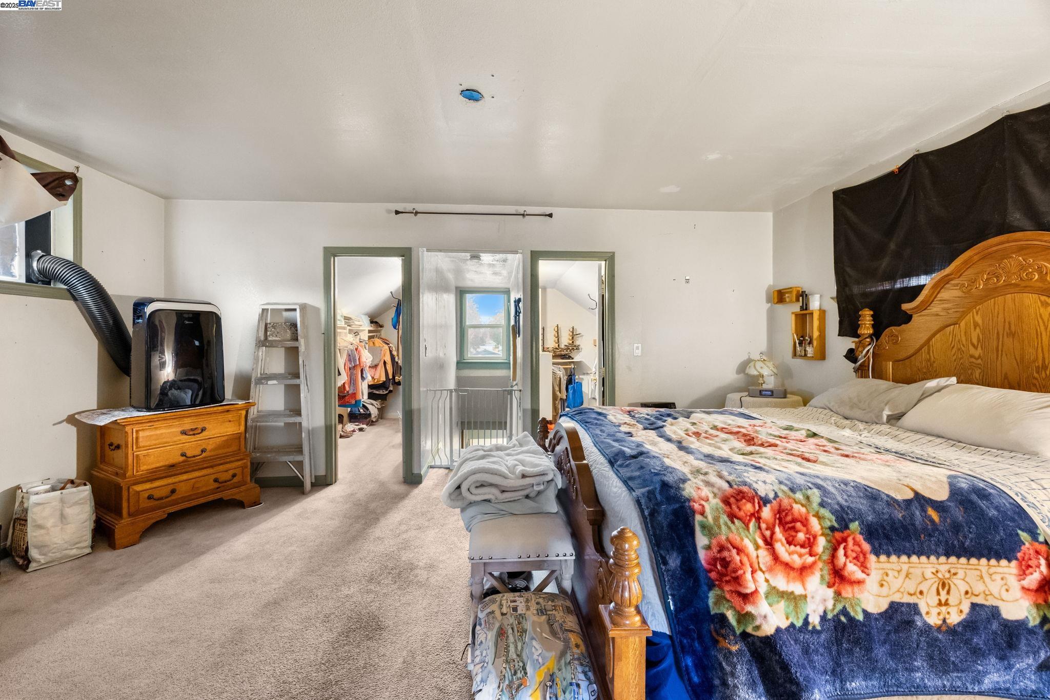 2421 West Rumble Road Modesto, CA 95350 - Photo 14 of 25 a bedroom with bed and glass door