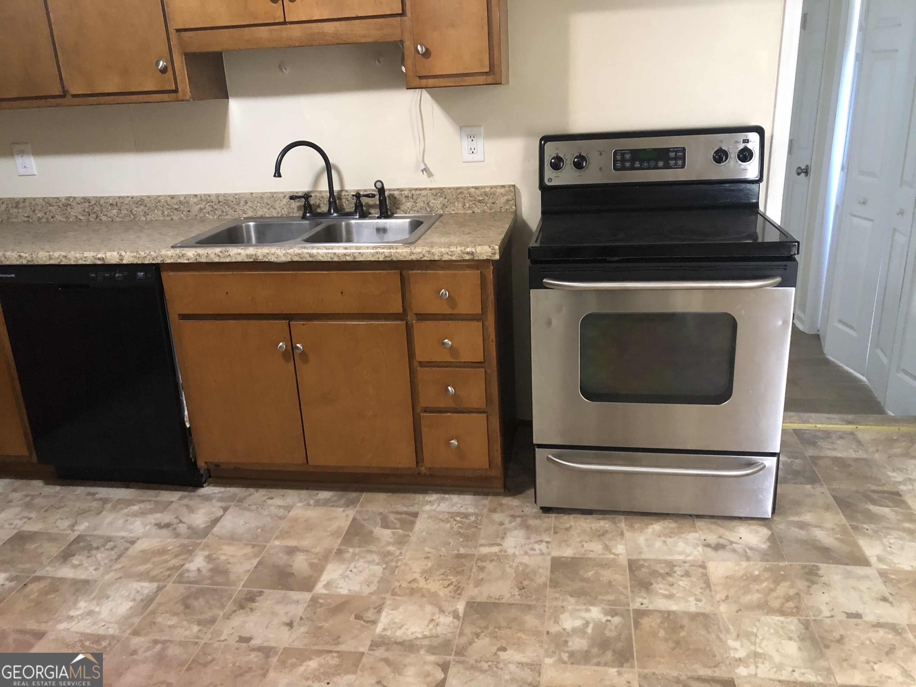 4454 Highway 3 Griffin, GA 30223 - Photo 4 of 23 a kitchen with granite countertop a stove and a sink
