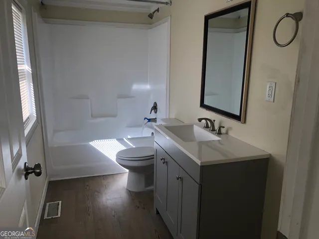 a bathroom with a sink toilet and tub