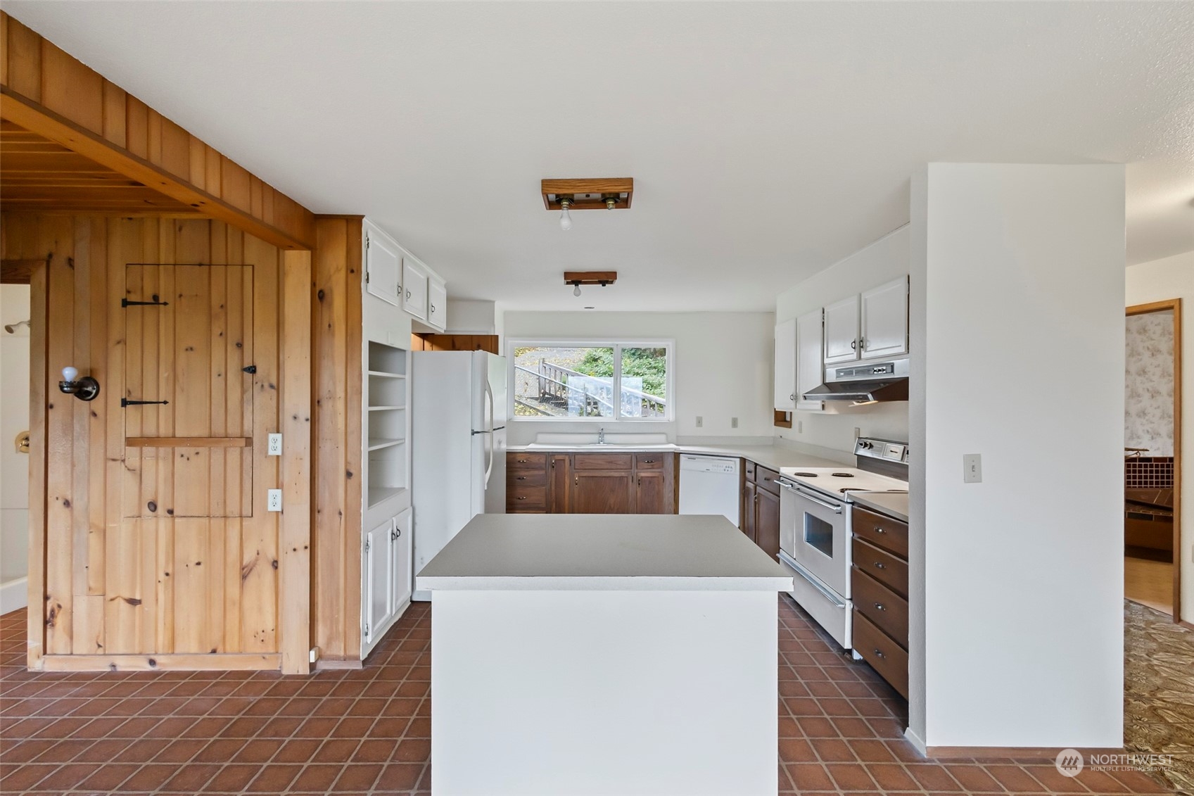 4865 Saratoga Road Langley, WA 98260 - Photo 14 of 40 a kitchen with stainless steel appliances a refrigerator a stove a sink dishwasher and a refrigerator with wooden floor
