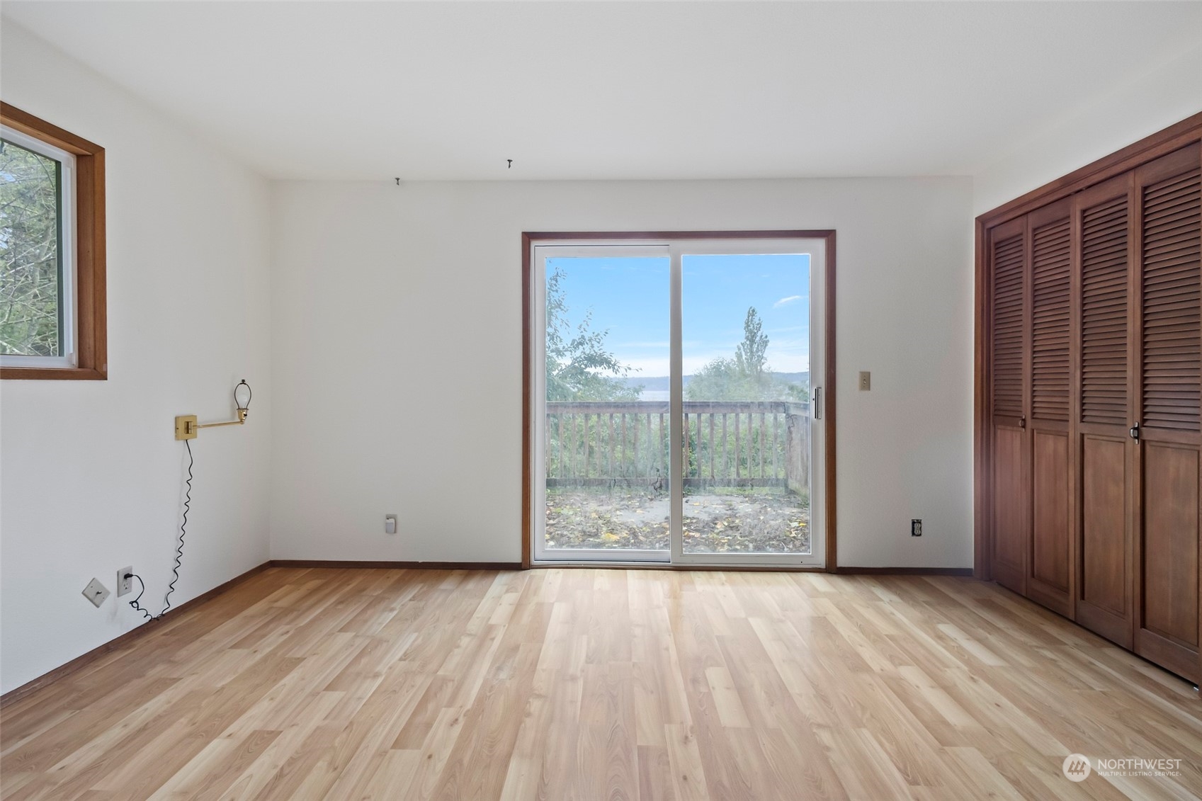 4865 Saratoga Road Langley, WA 98260 - Photo 20 of 40 an empty room with wooden floor and windows