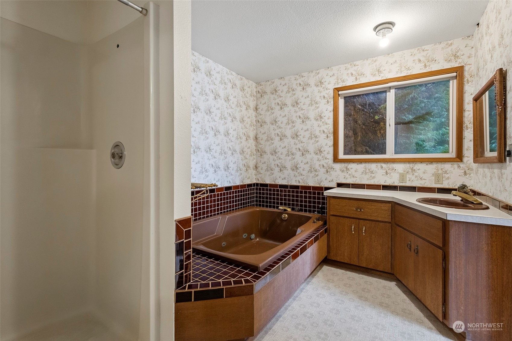 4865 Saratoga Road Langley, WA 98260 - Photo 22 of 40 a kitchen with a sink stove and cabinets