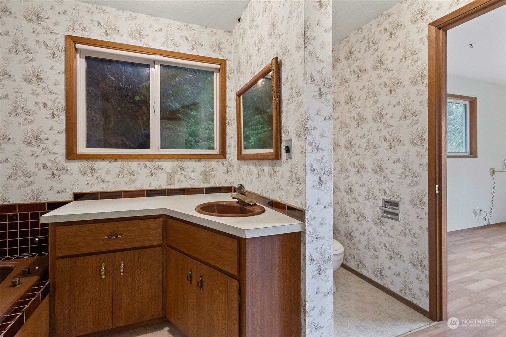 4865 Saratoga Road Langley, WA 98260 - Photo 23 of 40 a bathroom with a sink and a window
