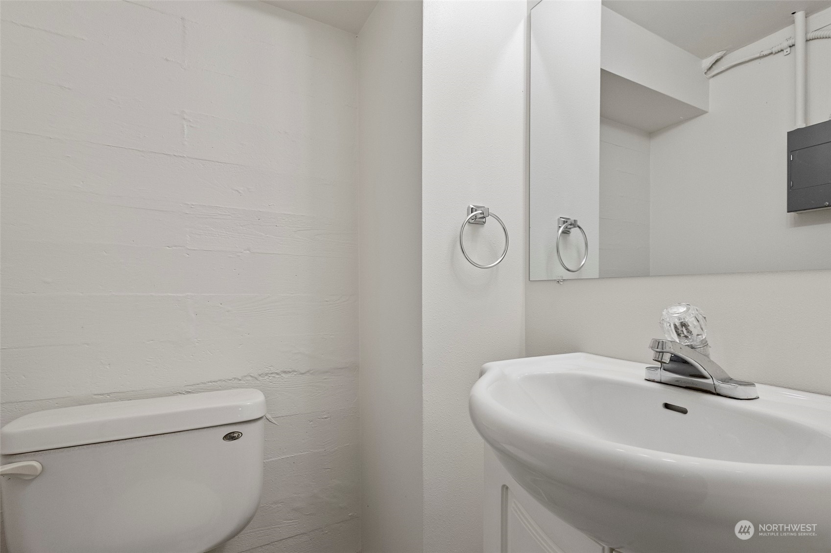 4865 Saratoga Road Langley, WA 98260 - Photo 29 of 40 a bathroom with a sink a toilet and a mirror