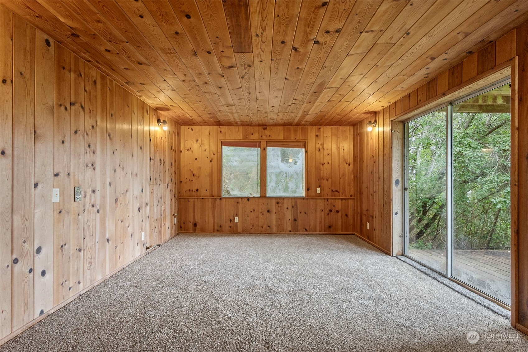 4865 Saratoga Road Langley, WA 98260 - Photo 33 of 40 a view of an empty room with wooden floor and a window