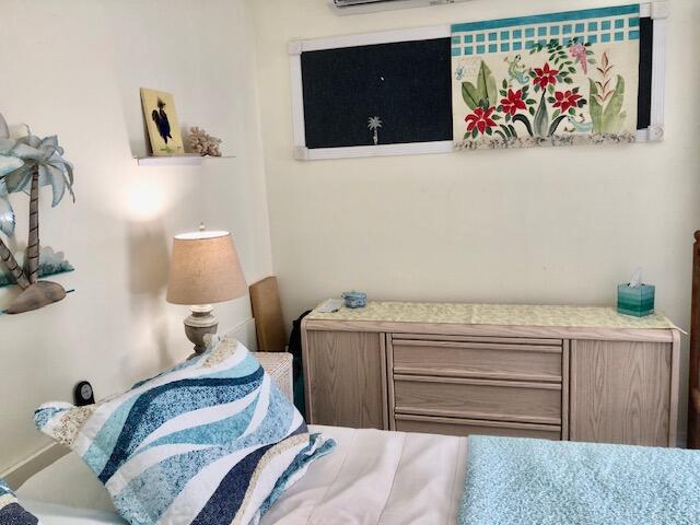 55 Boca Chica Road, Unit 132 Key West, FL 33040 - Photo 12 of 54 a bedroom with a bed and painting on the wall