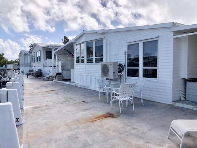 55 Boca Chica Road, Unit 132 Key West, FL 33040 - Photo 25 of 54 a view of a patio with a table and chairs