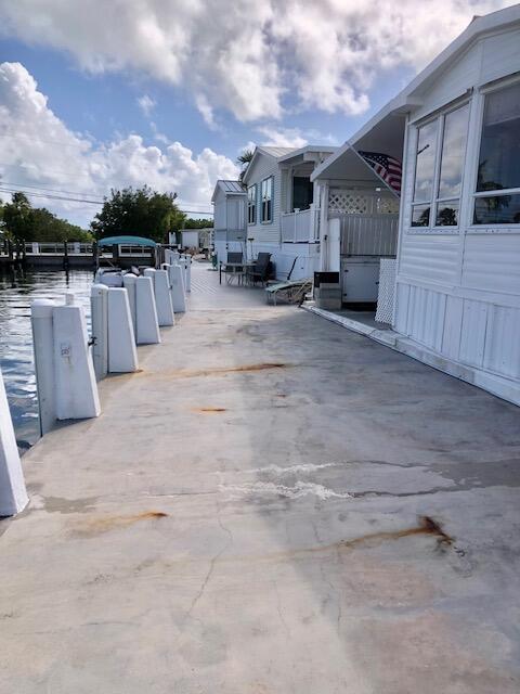 55 Boca Chica Road, Unit 132 Key West, FL 33040 - Photo 32 of 52 a view of a patio with table and chairs with wooden fence