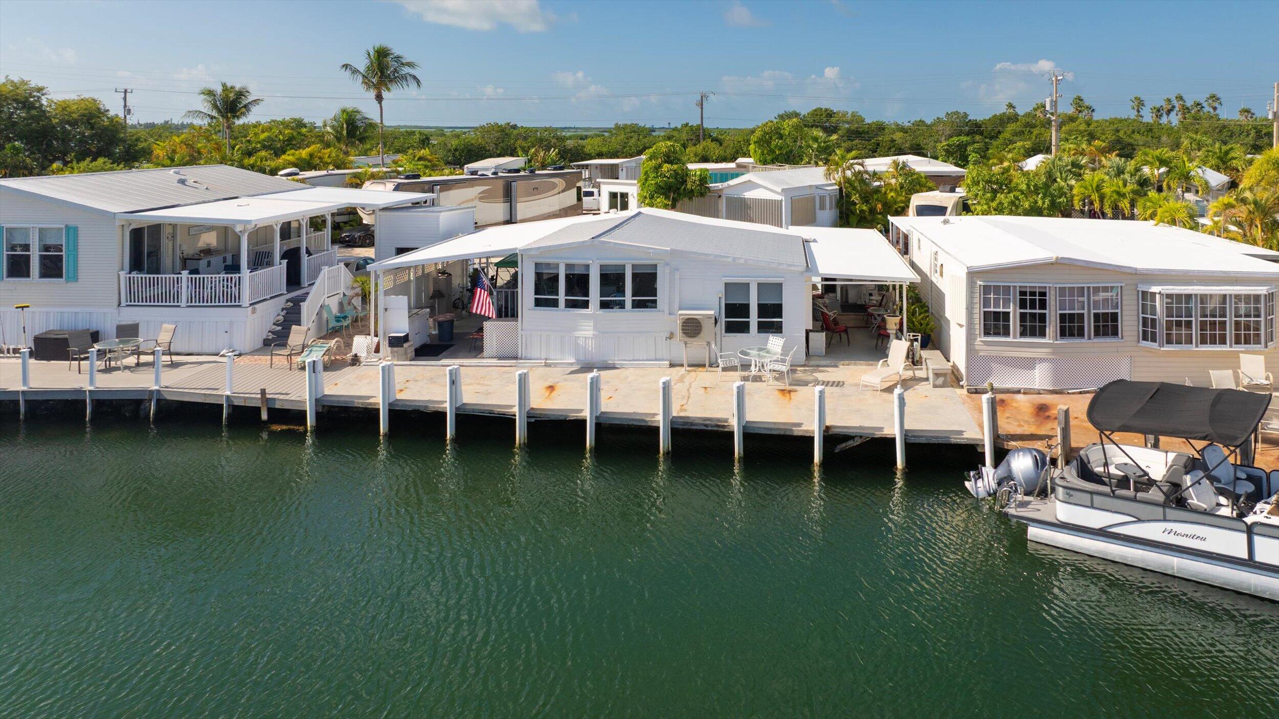 55 Boca Chica Road, Unit 132 Key West, FL 33040 - Photo 46 of 54 a view of a swimming pool with lawn chairs and a yard